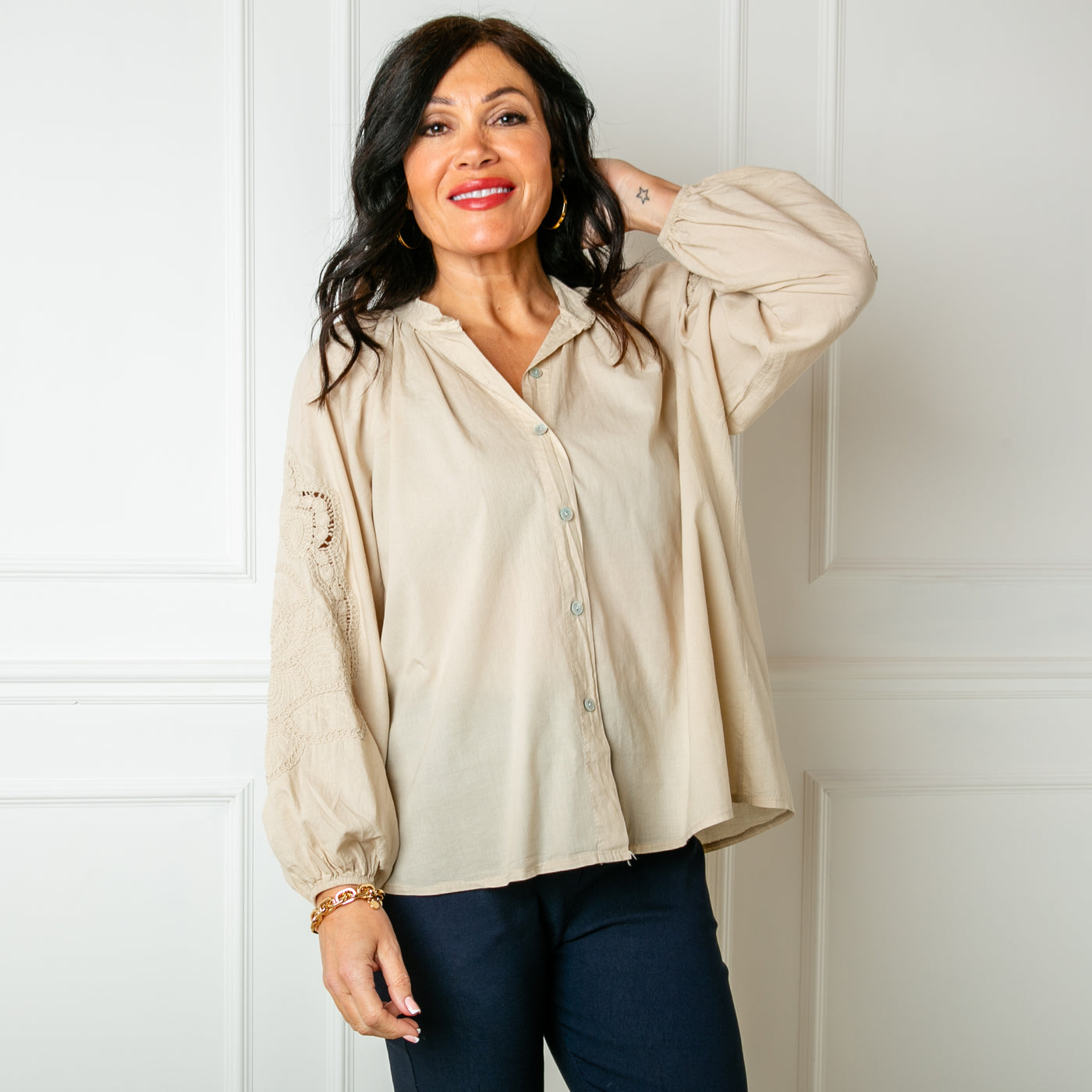 The stone cream Balloon Sleeve Shirt with a collarless V neckline and buttons down the front