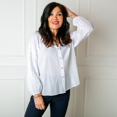 The white Balloon Sleeve Shirt with a collarless V neckline and buttons down the front