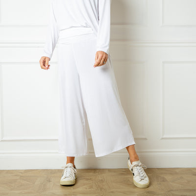 The white Bamboo Fold Over Pants with a wide leg silhouette in a soft and stretchy material