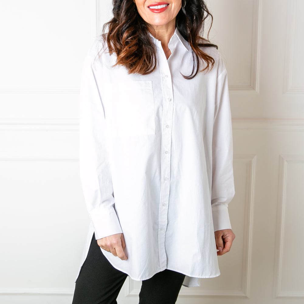 The Basics White Shirt with long sleeves that have button fastened cuffs on the end