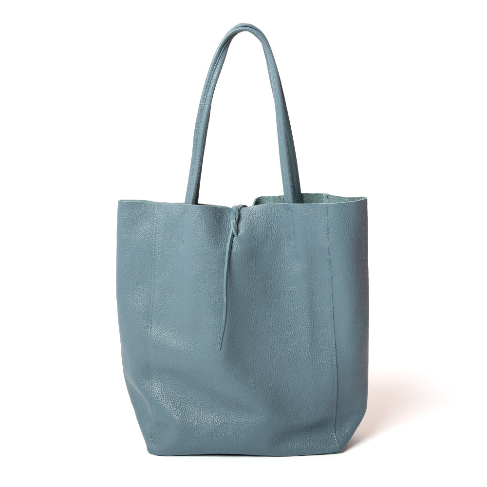 The denim blue Berlin Leather Tote Bag with a tie detail at the opening for fastening