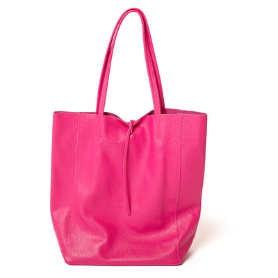 The fuchsia pink Berlin Leather Tote Bag with a tie detail at the opening for fastening