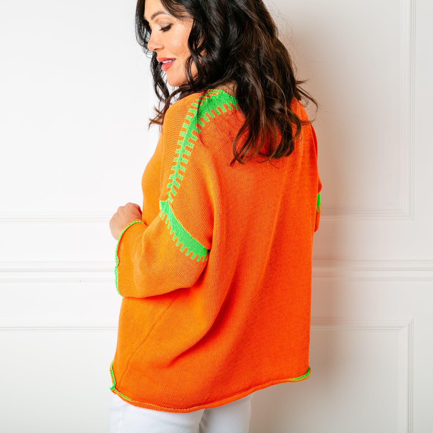 The orange Block Stitch Jumper with long flared sleeves and a v neckline