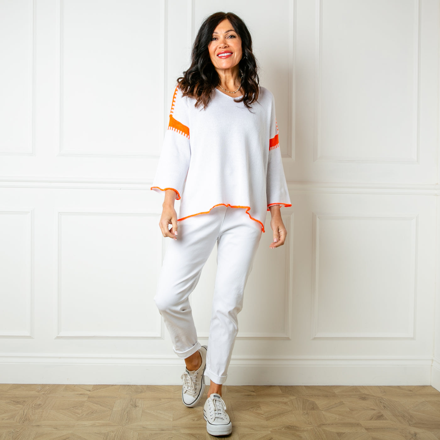 The white Block Stitch Jumper with long flared sleeves and a v neckline