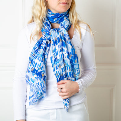 The blue Bora Bora Scarf featuring a beautiful spotty block print pattern with hints of gold foil dotted throughout