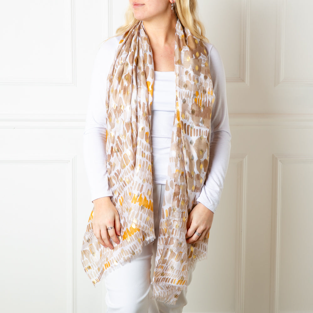 The taupe brown Bora Bora Scarf featuring a beautiful spotty block print pattern with hints of gold foil dotted throughout