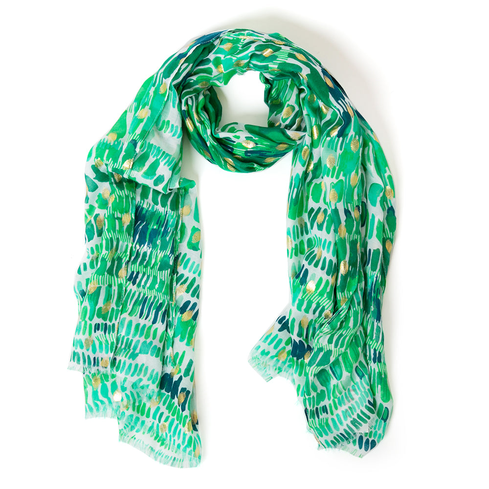 The Bora Scarf in green which can be worn in many ways including as a sarong on the beach