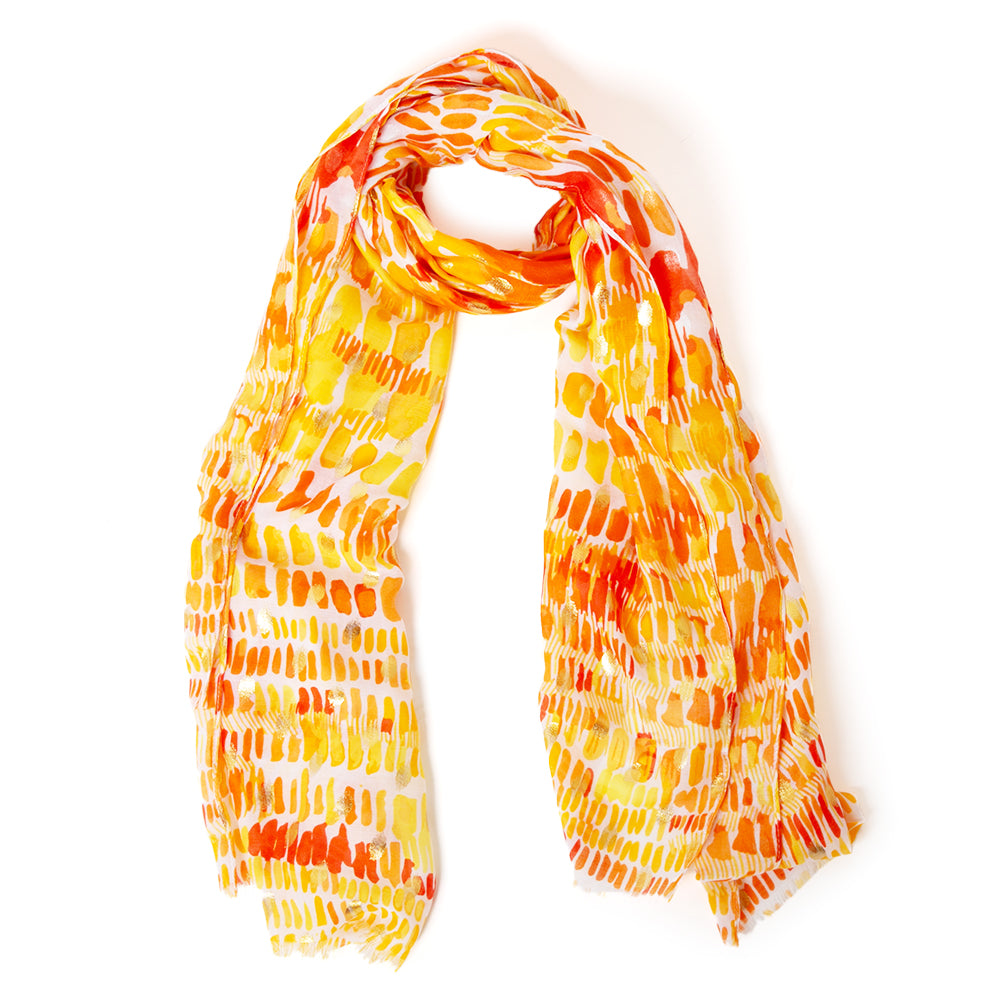 The Bora Scarf in orange which can be worn in many ways including as a sarong on the beach