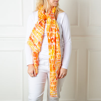 The orange Bora Scarf made from 100% viscose, super soft and lightweight, perfect for spring and summer