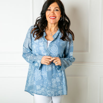 The dusky blue Botanical Cotton Blouse with long sleeves that can be rolled up and buttoned at the elbow