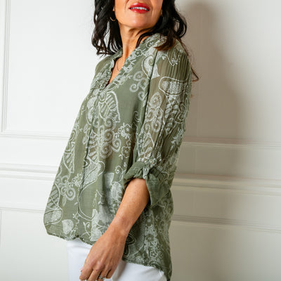 The khaki green Botanical Cotton Blouse with a collarless v neckline and buttons down to the bust