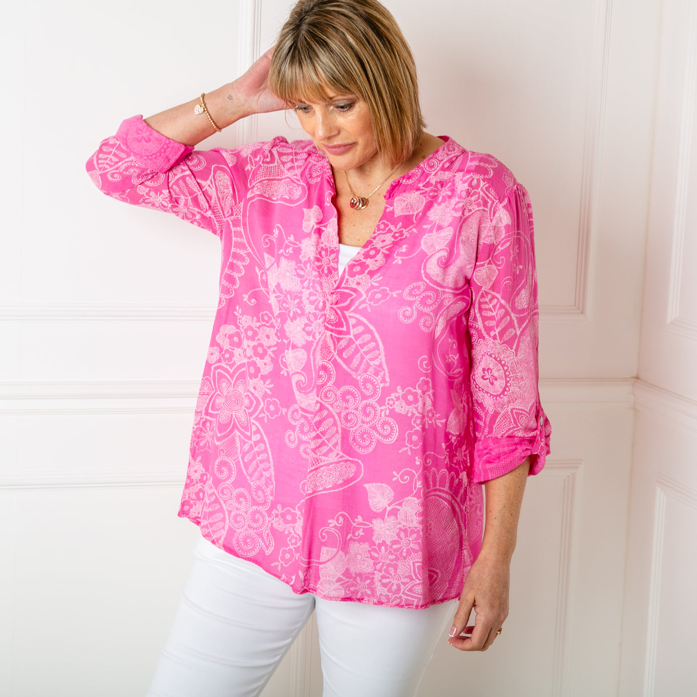 The pink Botanical Cotton Blouse with long sleeves that can be rolled up and buttoned at the elbow