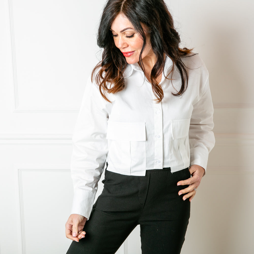 The Boxy Cropped Shirt in white with long sleeve that have a button fastening on the cuffs