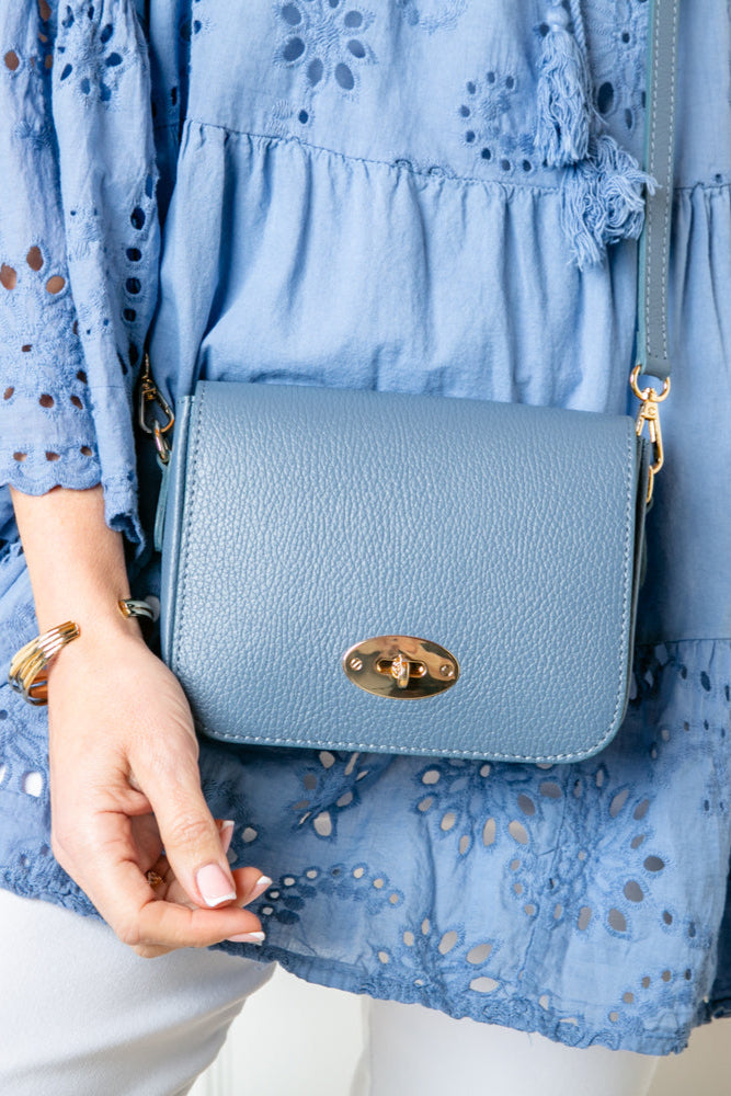 The denim blue Buckingham Leather Handbag which comes with a matching detachable strap to wear across the body