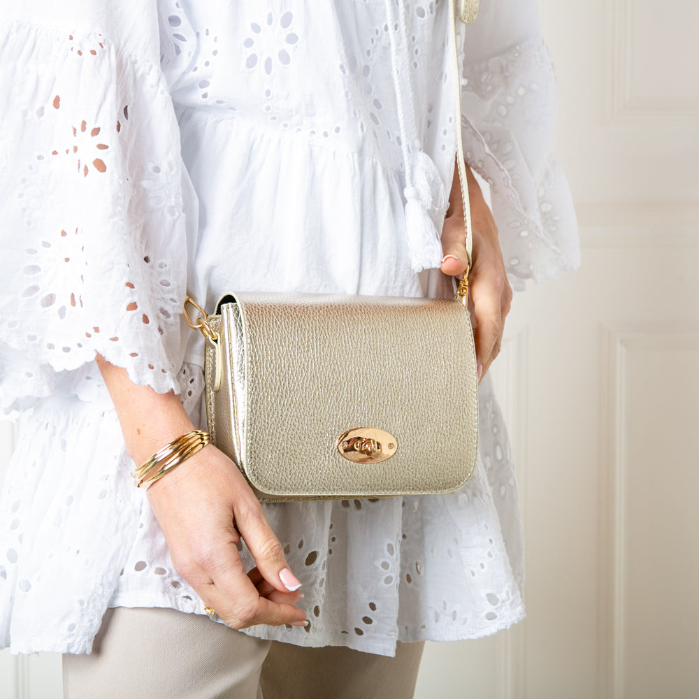 The gold metallic Buckingham Leather Handbag which comes with a matching detachable strap to wear across the body