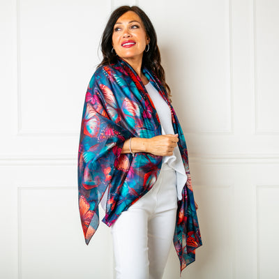 The Butterfly Silk Scarf in blue with hints of pink, red and purple