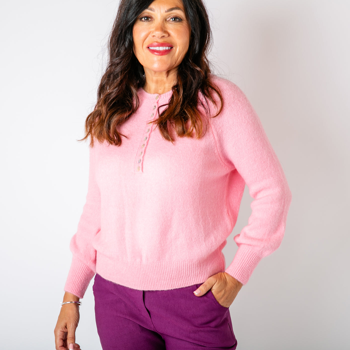 The candy pink Button Crew Alpaca Jumper with long sleeves and a round crew neckline