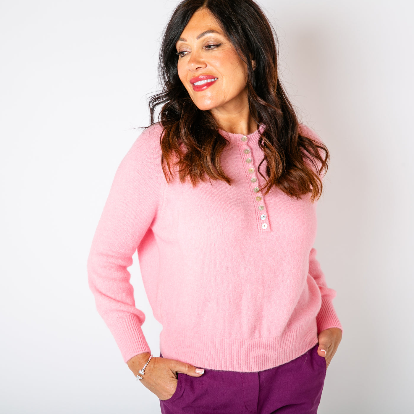 The candy pink Button Crew Alpaca Jumper with an iridescent button detail down the front