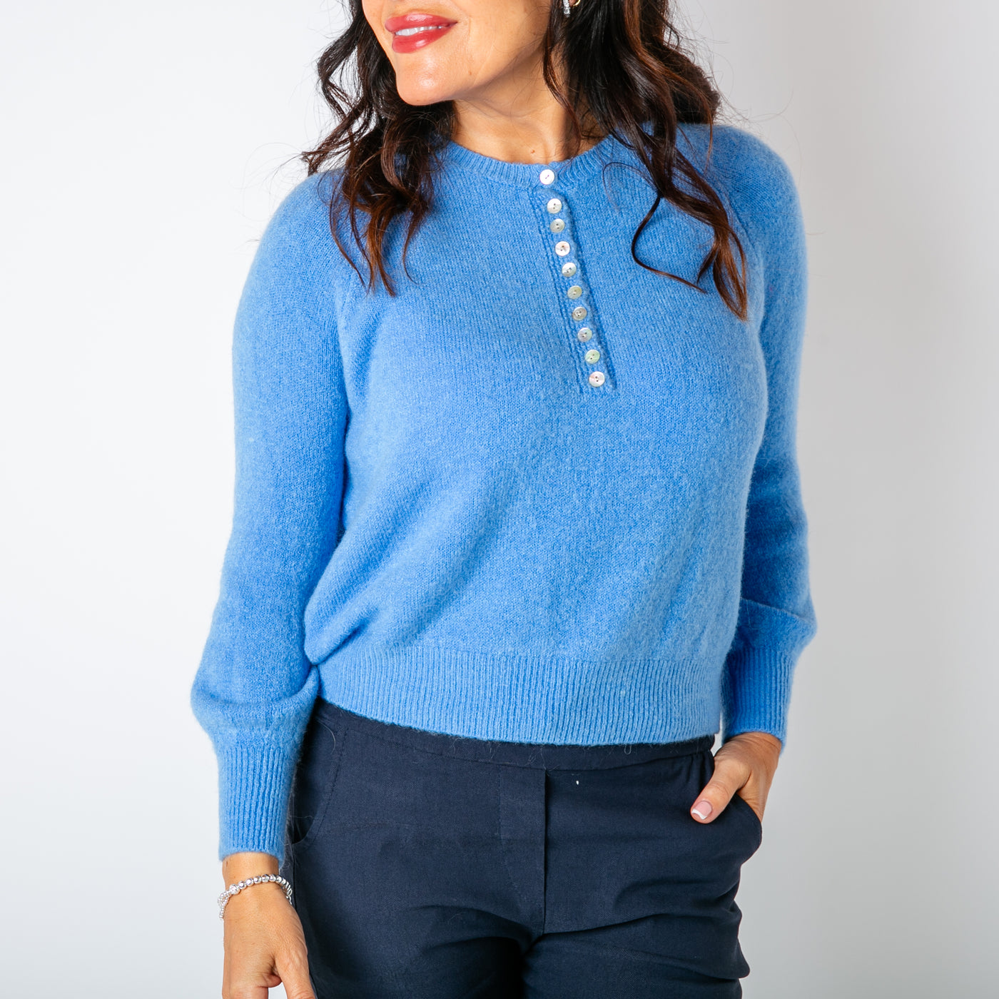 The cornflower blue Button Crew Alpaca Jumper with long sleeves and a round crew neckline