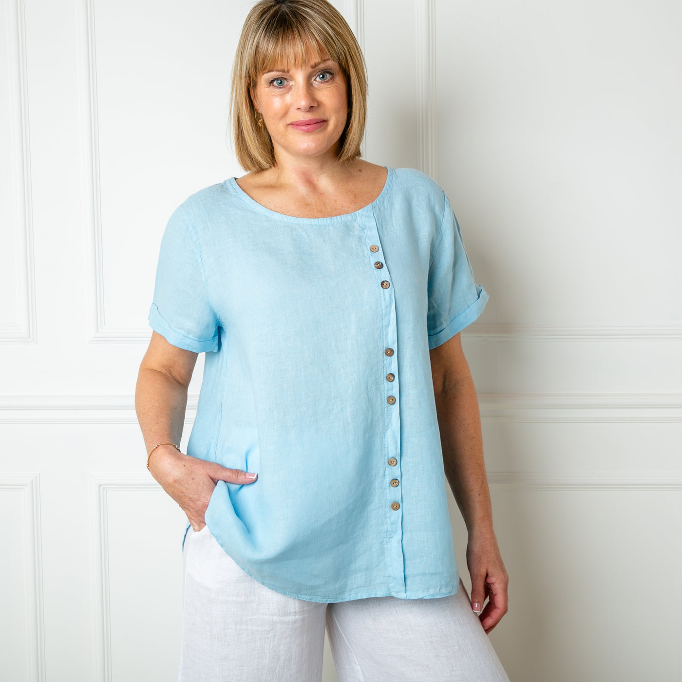 The baby blue Button Down Linen Top with short sleeves and a round neckline