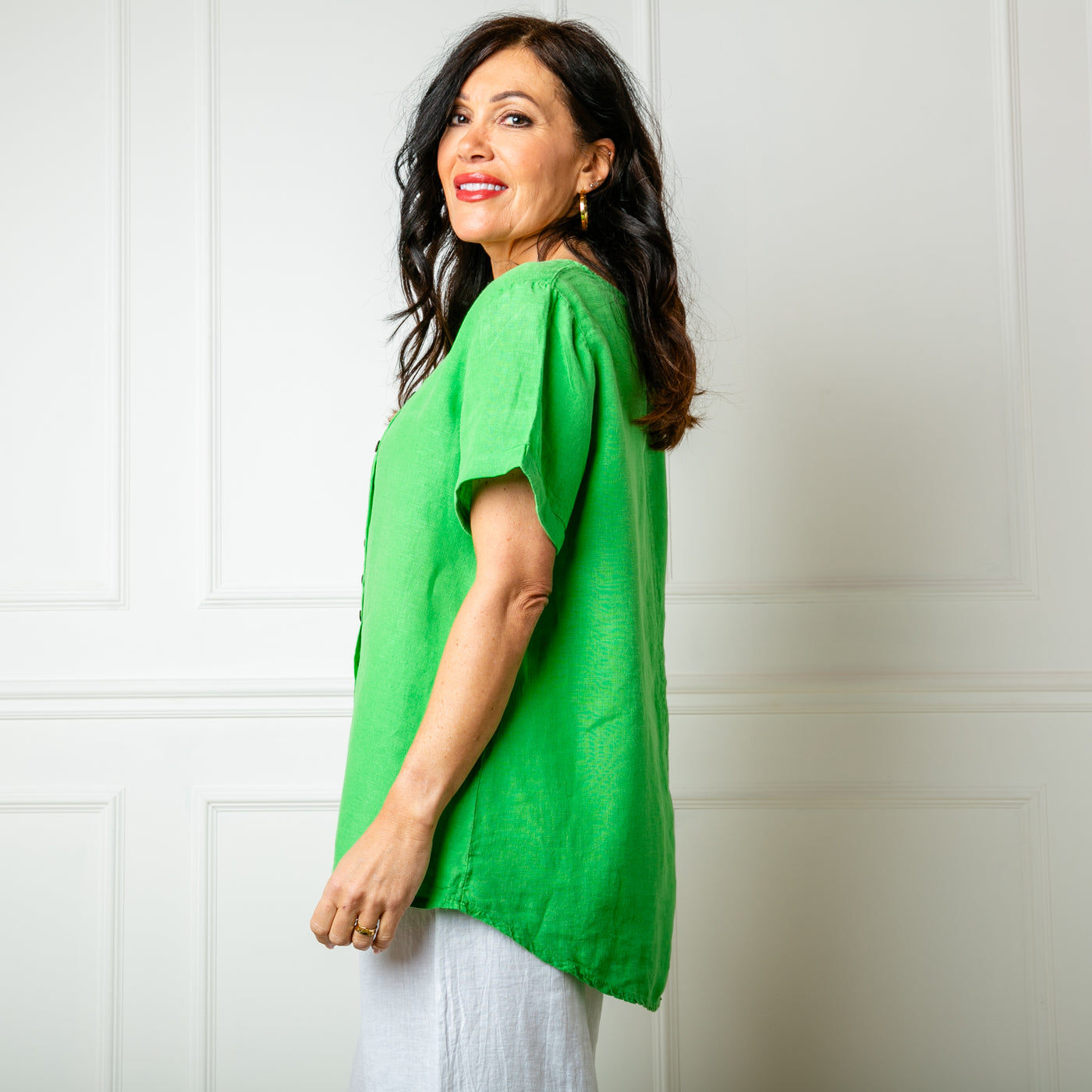 The emerald green Button Down Linen Top made from 100% linen, perfect for a lightweight, cool summer look