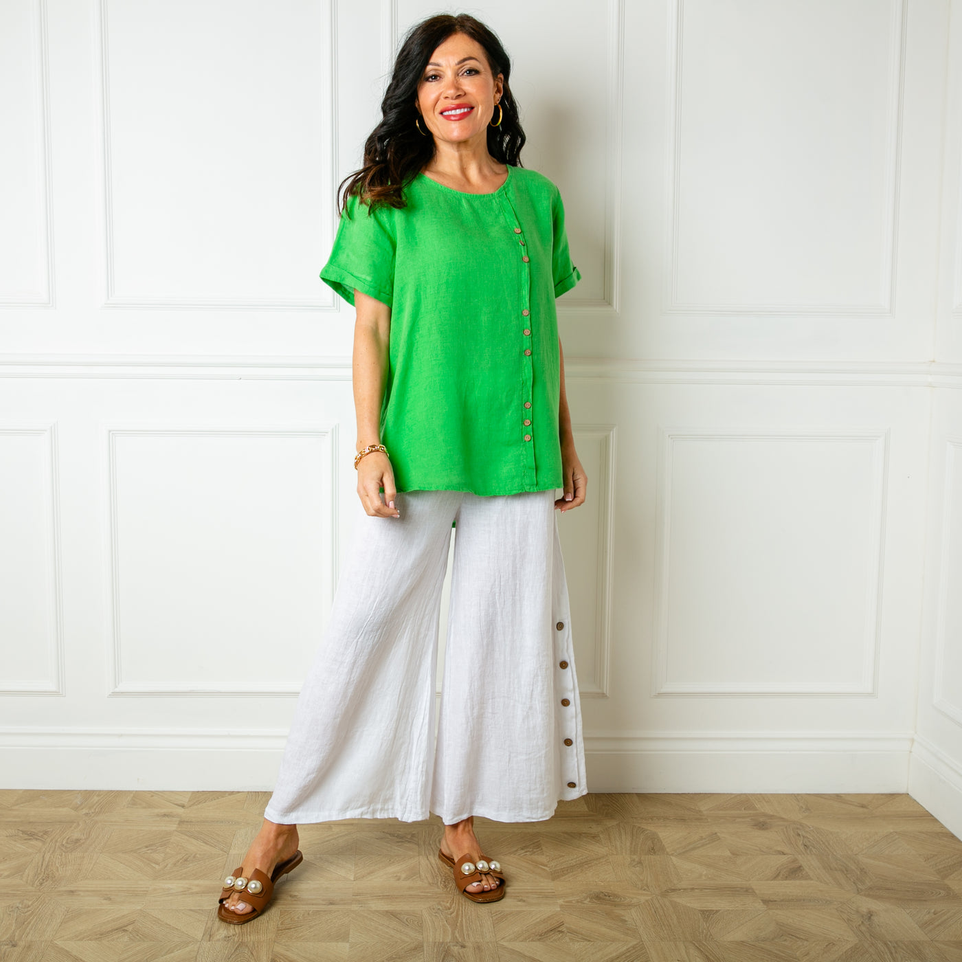 The emerald green Button Down Linen Top with small wooden button detailing down the front of the top 