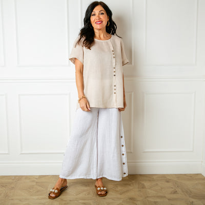 The natural cream stone Button Down Linen Top with small wooden button detailing down the front of the top 