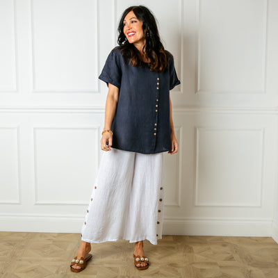 The navy blue Button Down Linen Top with small wooden button detailing down the front of the top 