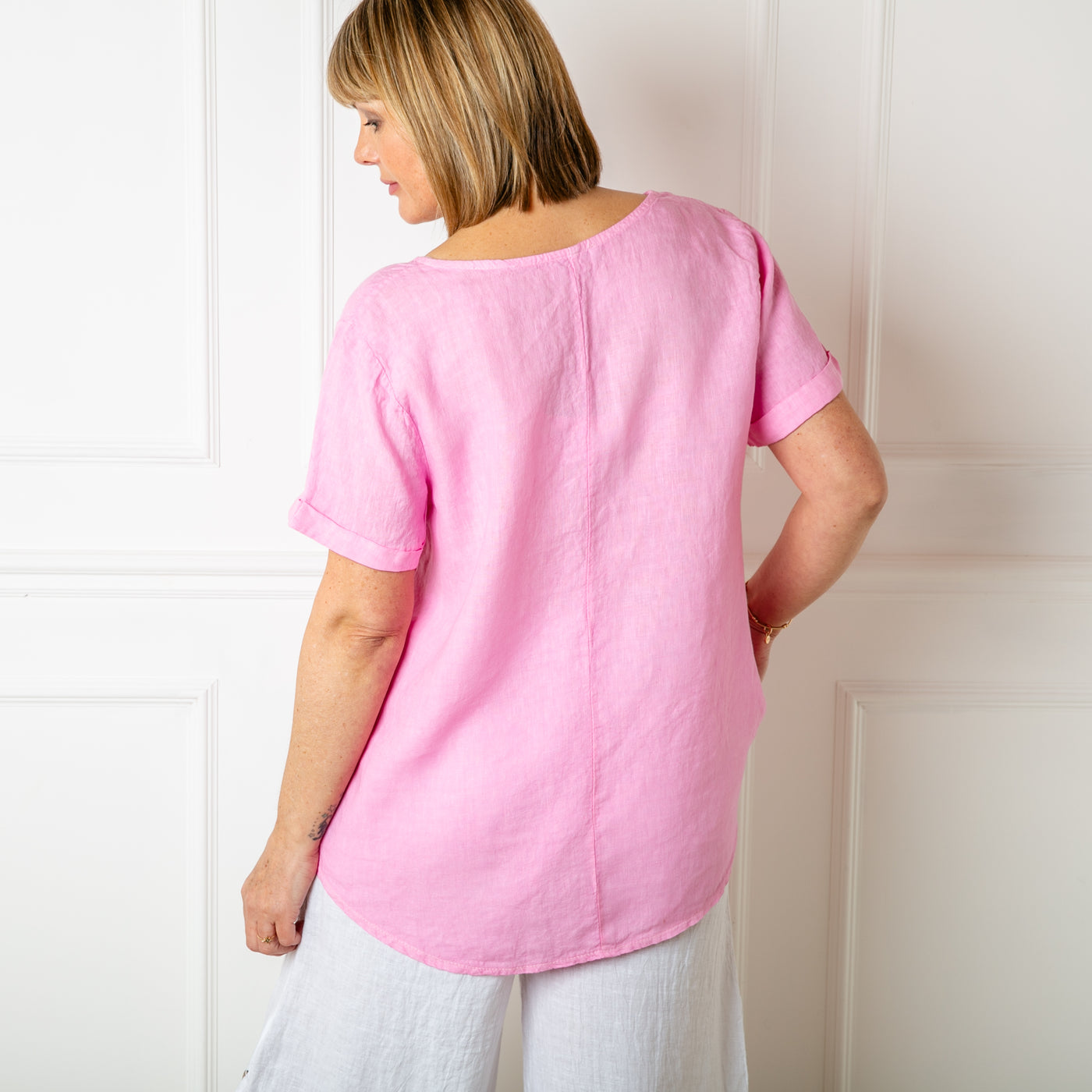 The pink Button Down Linen Top made from 100% linen, perfect for a lightweight, cool summer look