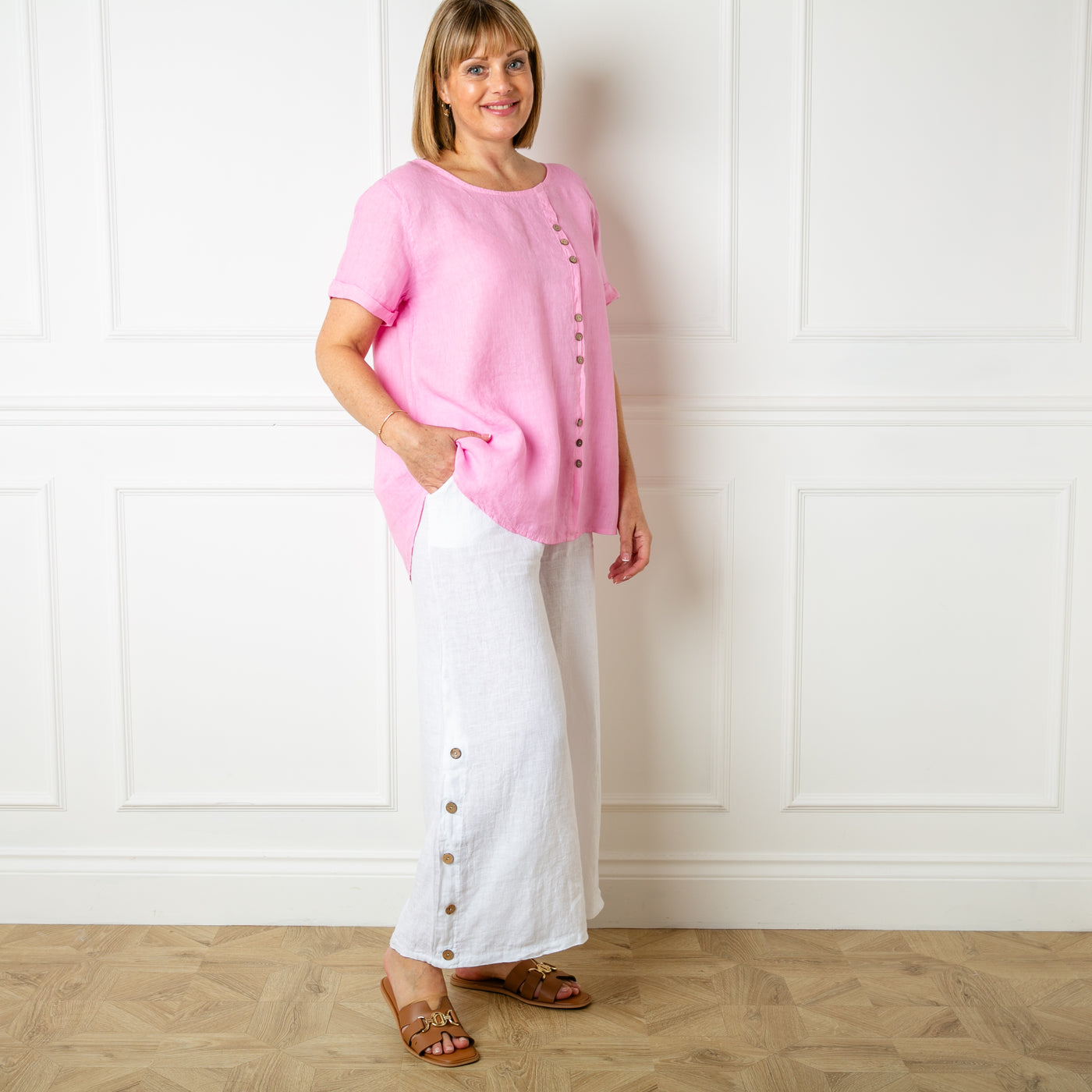 The pink Button Down Linen Top with small wooden button detailing down the front of the top 