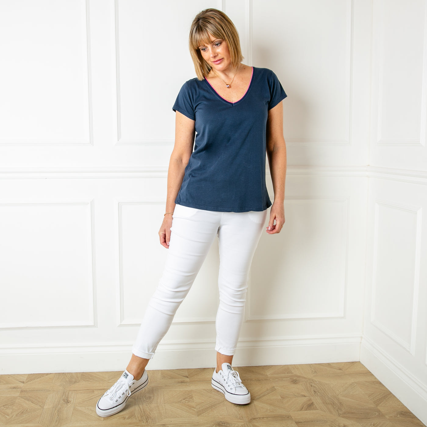 The Clashing T-shirt in navy blue with a contrasting pink trim around the neckline