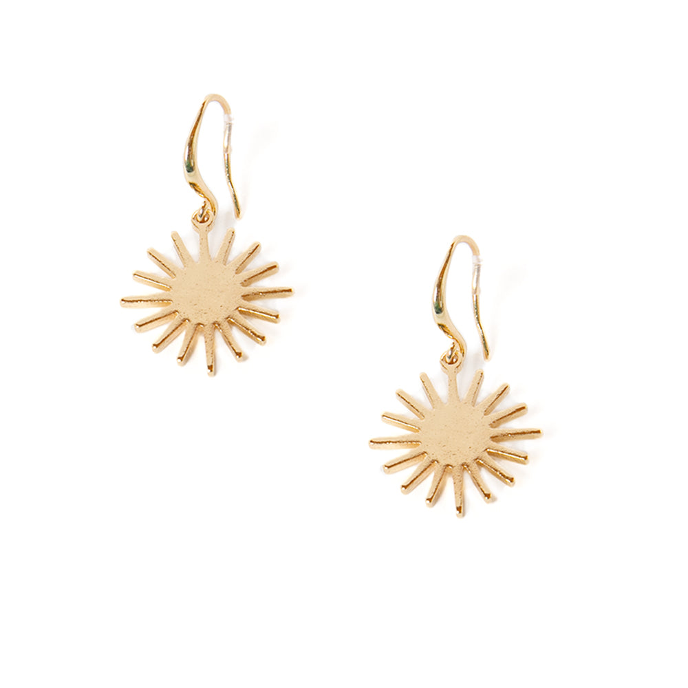 The Coco Earrings in gold in a sunshine shape with a hook fastening through the ear