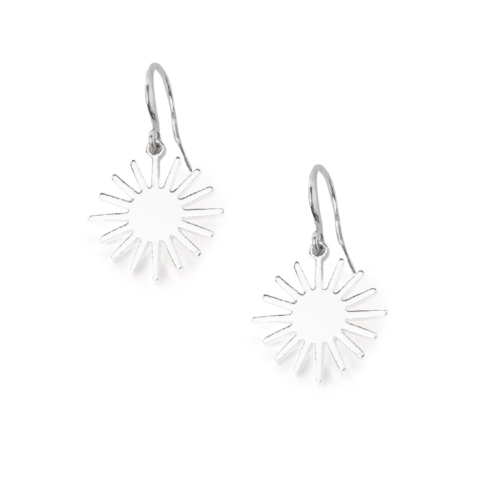 The Coco Earrings in silver in a sunshine shape with a hook fastening through the ear