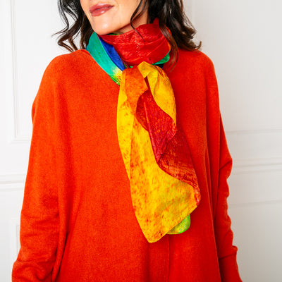The colour spectrum scarf pictured tied in a simple loop and worn as a neck scarf