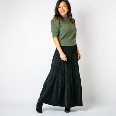 The Cord Tiered Skirt in black with a tiered circle skirt in a maxi length