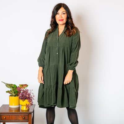 The Corduroy Tiered Dress in khaki green with buttons down the front for fastening