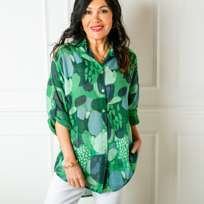 The Cotton Spot Print Shirt in green with long sleeves that can be rolled and fastened at the elbow