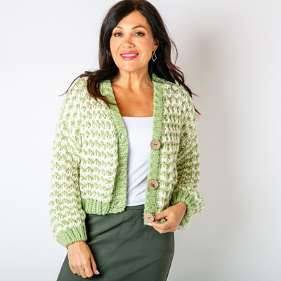 The green Cropped Chunky Knit Cardigan with ribbed detailing around the cuffs opening and bottom hemline