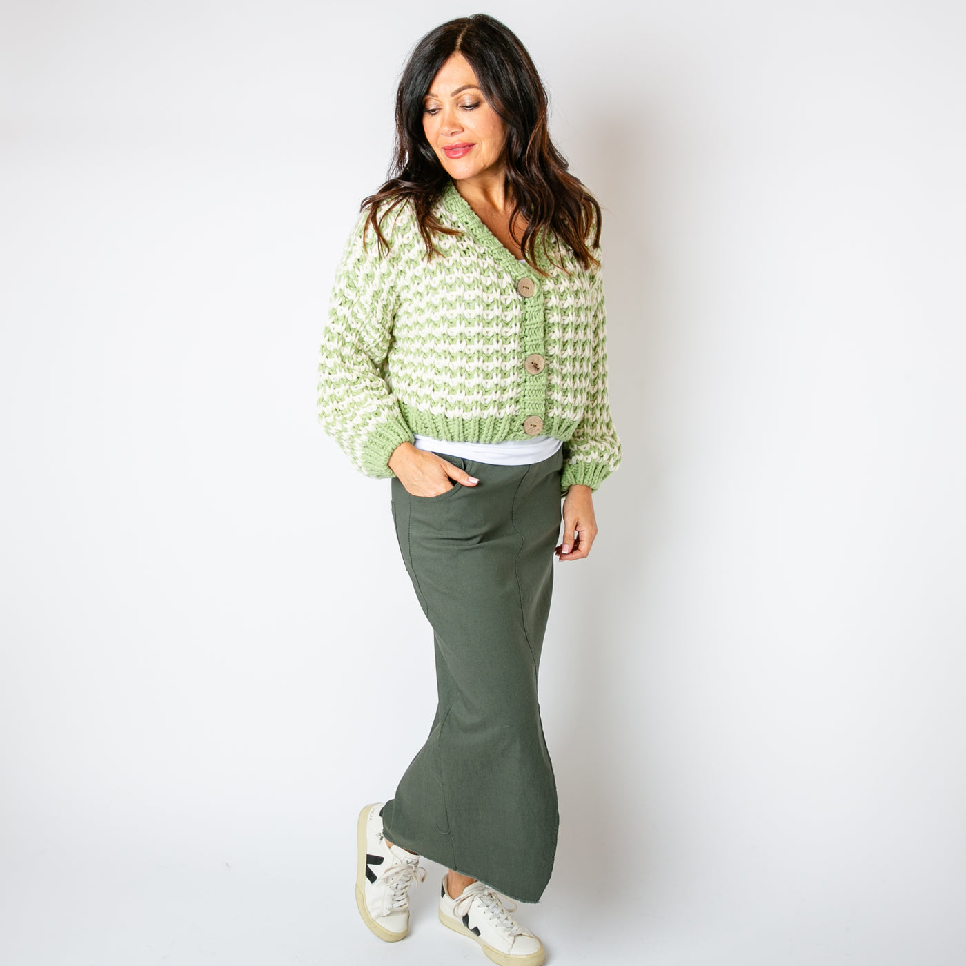 The green Cropped Chunky Knit Cardigan with large wooden buttons down the front for fastening