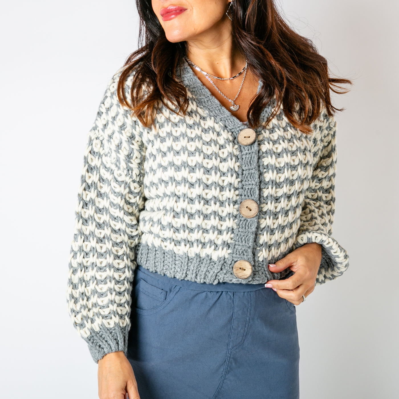 The grey Cropped Chunky Knit Cardigan with large wooden buttons down the front for fastening