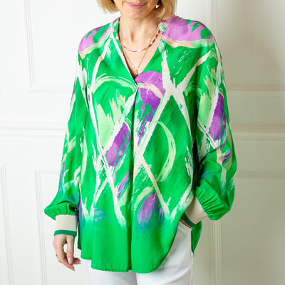 The green Crossing Pattern Jersey Cuff Top with undertones of purple and cream