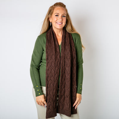 The chocolate brown Daphne Cable Knit Scarf featuring an intricate braided knitted pattern