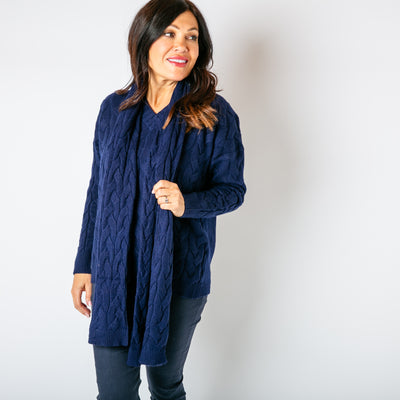 The navy blue Daphne Cable Knit Scarf which is super soft and perfect for chilly days