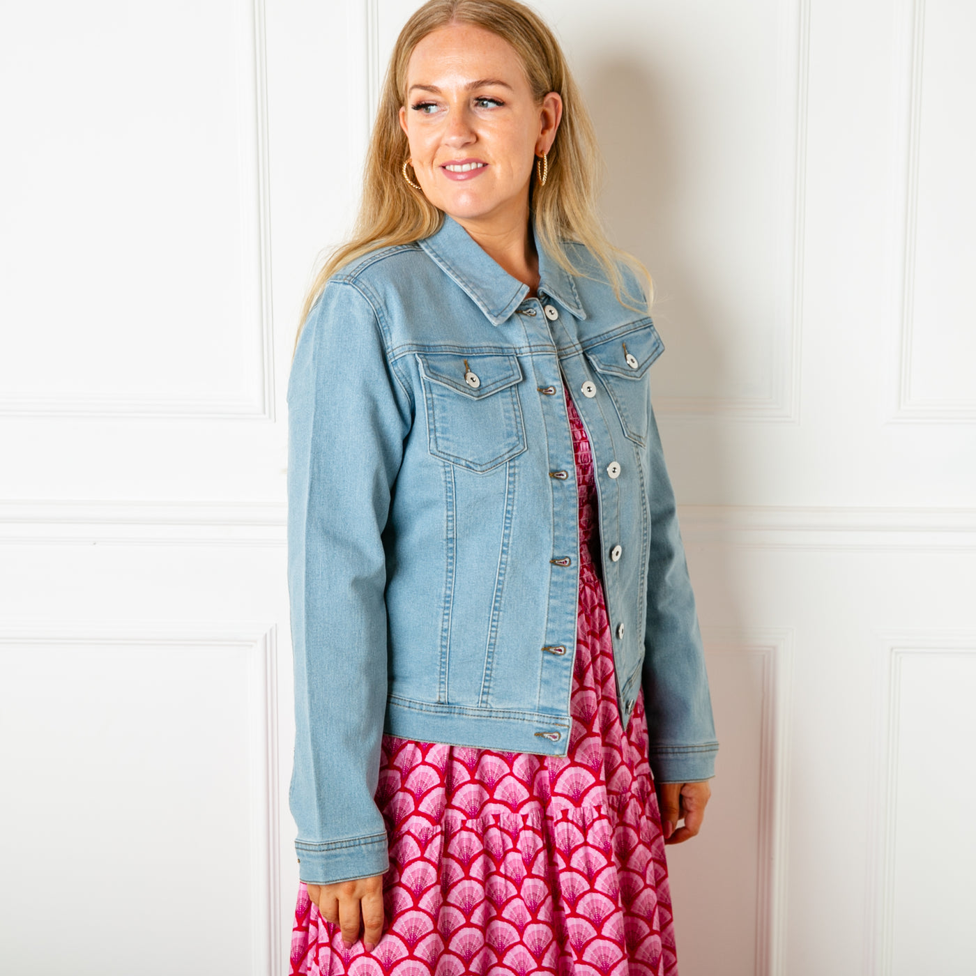 The mid blue Denim Jacket with pockets on either side of the bust with button fastenings