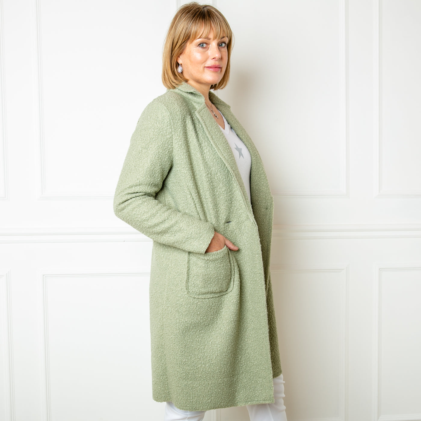 The Double Breasted Coat in sorbet green with a shirt collar, long sleeves and a double breasted button fastening