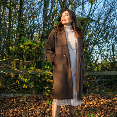 The chocolate brown Double Faced Coat with pockets on either side of the hips