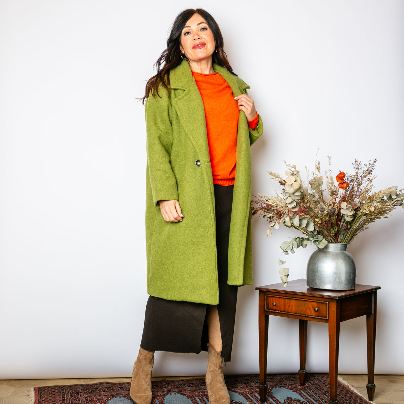 The pistachio green Double Faced Coat with pockets on either side of the hips