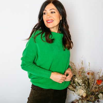 The Drop Sleeve Jumper in emerald green with long sleeves that have a ribbed detailing to the elbow