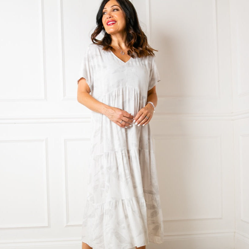 The Eden Dress in white with short sleeves and a v neckline