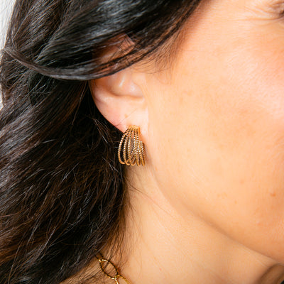The gold Ennis Earrings made up of five delicate hoops joined at either end